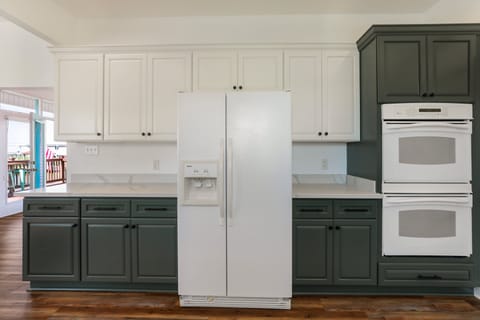 Full sized side-by-side refrigerator with water and ice in the door.