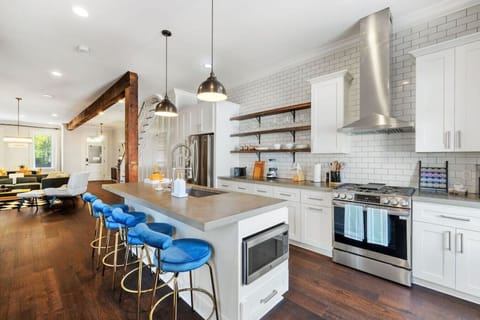 An expansive kitchen space highlighted by a generous kitchen island adorned with plush bar seating, offering both functionality and comfort.