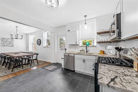 Bright view of the Kitchen and Dining area - the emergency door leads to the deck and backyard