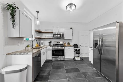 Enter the functional kitchen! You'll find granite countertops, plenty of counter space, and cabinets for all your vacation goodies.