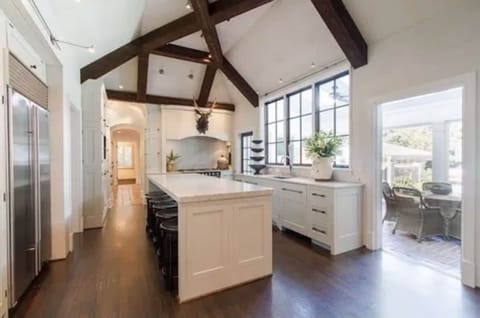 Kitchen with vaulted ceilings with La Cornue CornuFé stove & marble countertops
