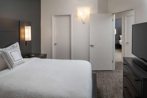 Settle in for a quiet night with TV and cozy bedding.