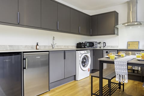 Fully equipped kitchen with sleek, modern appliances, perfect for cooking up your favorite meals during your stay.