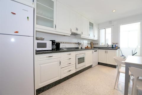 Modern kitchen in this apartment is fully equipped with all the appliances