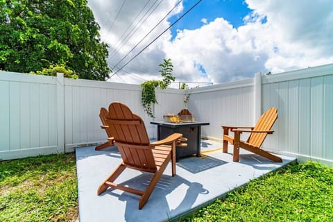 Patio furniture in front of the fire pit to lounge away in the backyard.