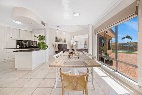 This spacious kitchen and dining area is perfect for cooking. It features a large island, and a dining table that can accommodate a large group.