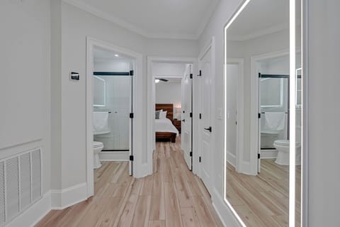Hallway with a view of the guest bathroom and master bedroom.