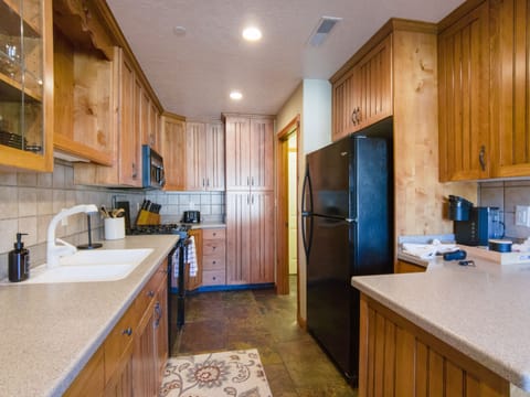 Kitchen with gas range, full settings for 10 and a Keurig coffee station.