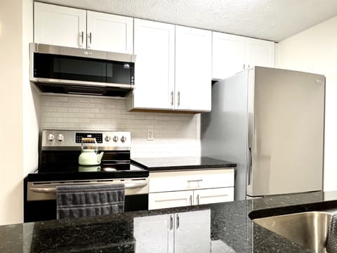 New kitchen with stainless appliances. 