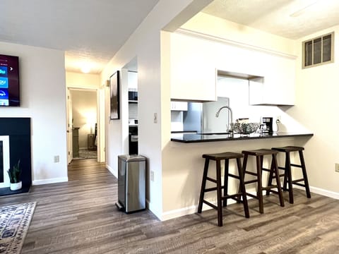 Newly renovated kitchen with black granite and stainless appliances.