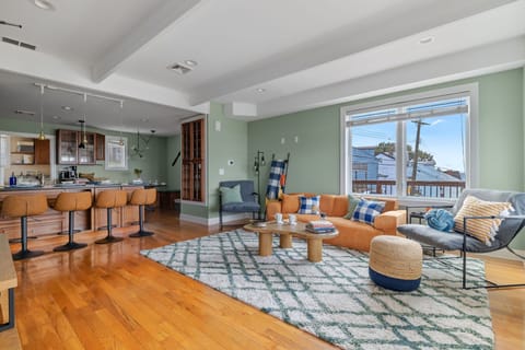 Open concept area featuring living room, dining area, and kitchen