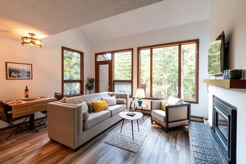 Living room and dining area with ample natural light.