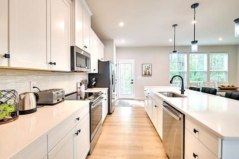 second level spacious kitchen opens door to Patio with Tree line Views.