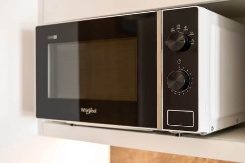 A close-up of a modern microwave neatly placed on a countertop, showcasing a functional and stylish appliance.