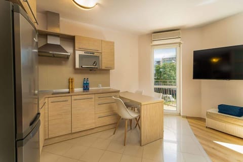 Another perspective of the kitchen and dining space, showcasing its modern appliances and cozy design.
