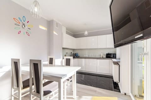 A compact dining area with a white table and chairs, located near the kitchen for convenience.
