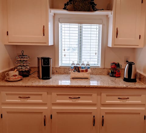 Stocked coffee and tea bar at one end of the kitchen.