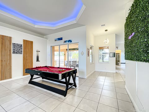 Modern Boho vibes transform this spacious area—complete with a pool table and unique lighting