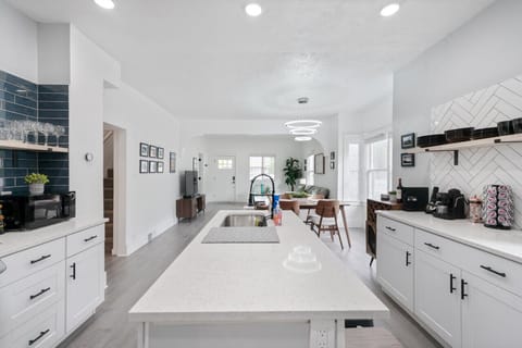 A white-themed with accent of black kitchen for a clean, bright, and inviting space