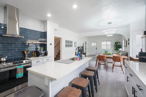 Kitchen island offers extra workspace, storage, and often seating, making it a hub for cooking and socializing in the kitchen.