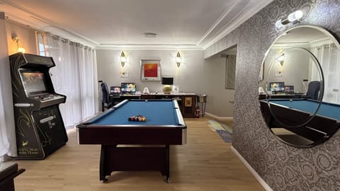 Versace wallpaper with a 120cm designer mirror, timber floor, Arcade gaming.
