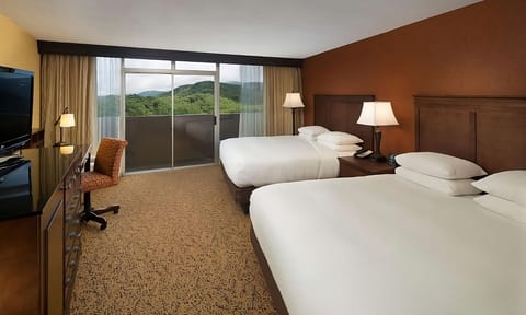 Stretch out on two plush beds with scenic window light.