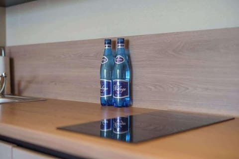 A closer look at the kitchen countertop, showcasing appliances and bottled water for convenience.
