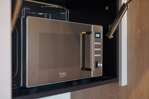 A microwave integrated into the kitchen cabinetry, emphasizing functionality and modern design.

