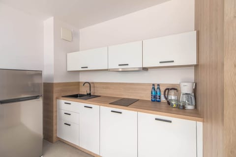 Kitchenette with a fridge.