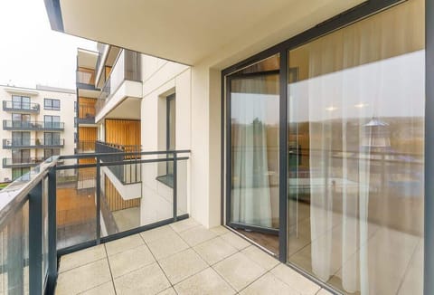 The balcony's stylish design complements the apartment's decor. 