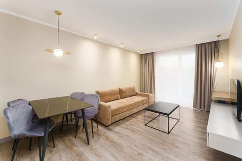 Relax in the stylish living room with a comfortable sofa and cosy decor.