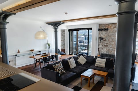 Open plan living space with balcony and marina views