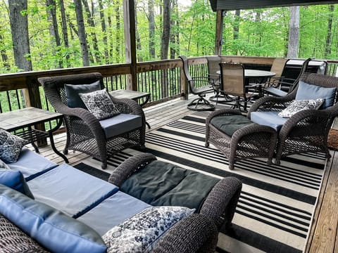 The covered outdoor living space offers plenty of spots to relax and chill as well as a table and chairs for outdoor meals!