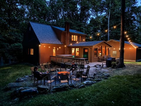 Unwind beneath the string lights in your own secluded backyard—complete with a hot tub, fire pit, and nothing but forest around you.