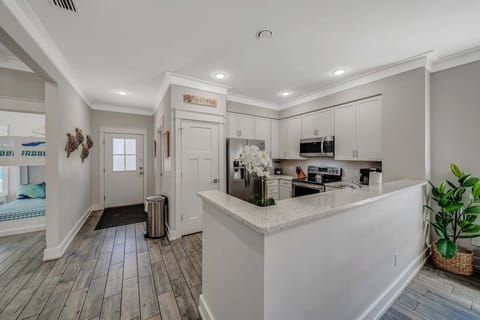 The fully equipped kitchen features beautiful recycled glass countertops and stainless-steel appliances.