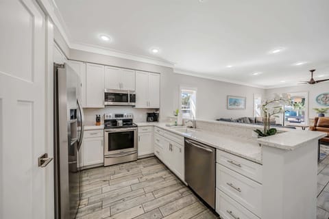 The fully equipped kitchen features beautiful recycled glass countertops and stainless-steel appliances.