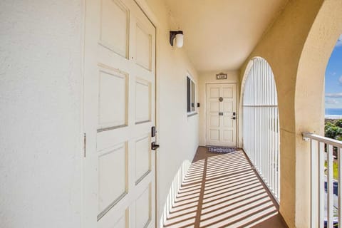 - Condo walkway with arched design leading to guest entry doors and ocean views  
- Bright natural light and fresh air create a welcoming arrival for every stay  
- Convenient safe access makes moving in and out easy for visiting families  