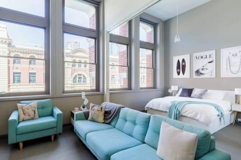 Soaring windows drench the space in natural light—with black-out blinds to encourage a sleep in. 