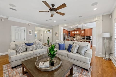 Experience the perfect blend of open concept living with this inviting space, where the living room seamlessly flows into a spacious kitchen nestled in the background.