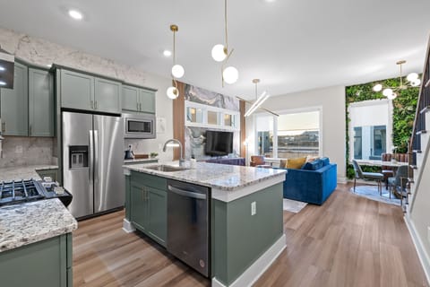 Open-Concept living area open to the dining area and kitchen with queen sized sleeper sofa