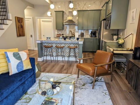 Enjoy a casual meal at the stylish breakfast bar while staying connected with loved ones relaxing in the cozy seating area.