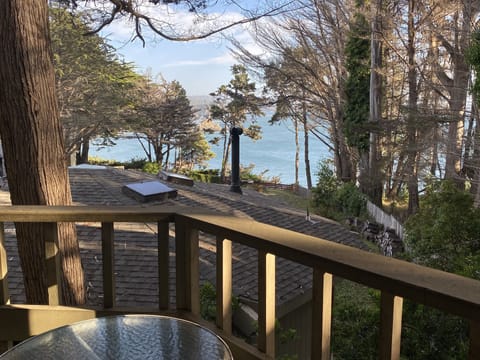 Your private balcony with table & chairs &  a roof-top view of the Pacific Ocean