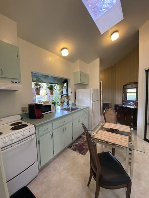 The kitchen with the front door in the backgrond