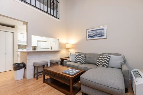 Relax on your spacious sectional sofa in this bright loft-style living room, with a fully equipped kitchen steps away for all your culinary needs.