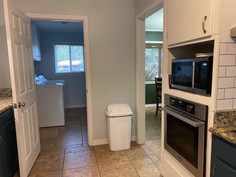 View from kitchen into laundry on left  and dining room on right.