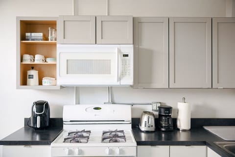 Fully equipped kitchen with modern appliances, offering a seamless blend of historic charm and convenience.