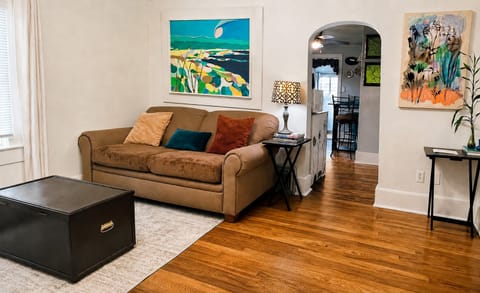 Living room with freshly painted walls and newly refinished original oak floors.