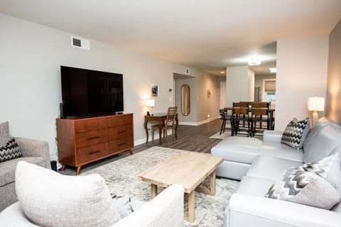 Open plan living room with large TV & dining area to accommodate guests.