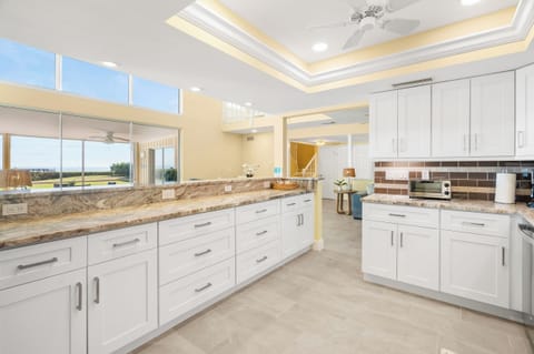 Your gourmet kitchen features pristine white cabinetry, stunning granite countertops, and modern appliances for all your culinary adventures.