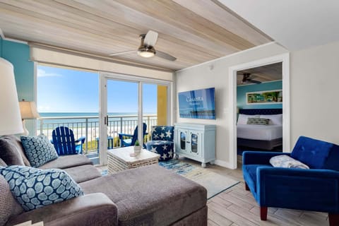 Immerse yourself in coastal luxury with this stunning living space! Featuring plush seating, vibrant nautical decor, and breathtaking ocean views from the balcony, this retreat combines comfort and style for the ultimate seaside getaway.